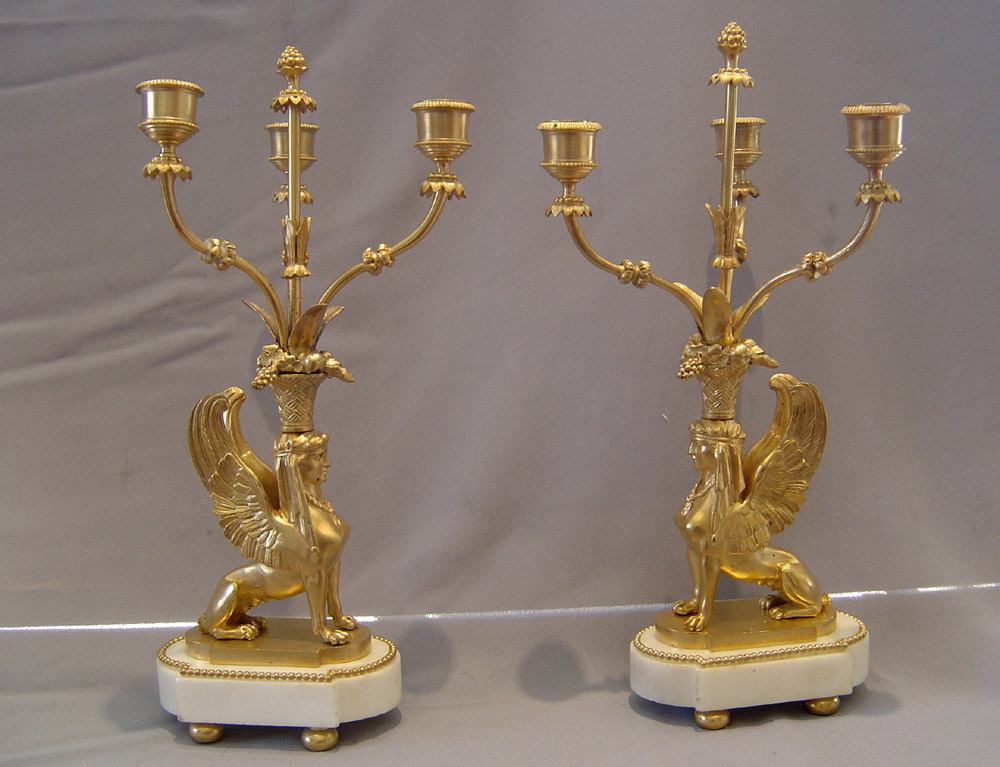 French antique sphinx candelabra, a pair in ormolu and white marble.