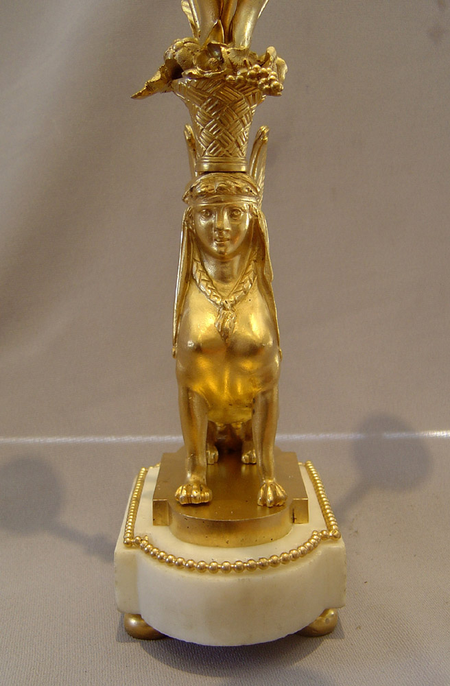 French antique sphinx candelabra, a pair in ormolu and white marble.