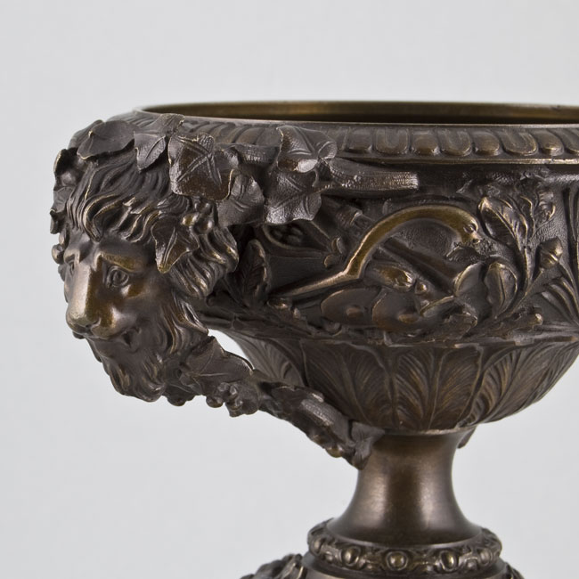 Pair of late Victorian bronze vases on black marble columns.