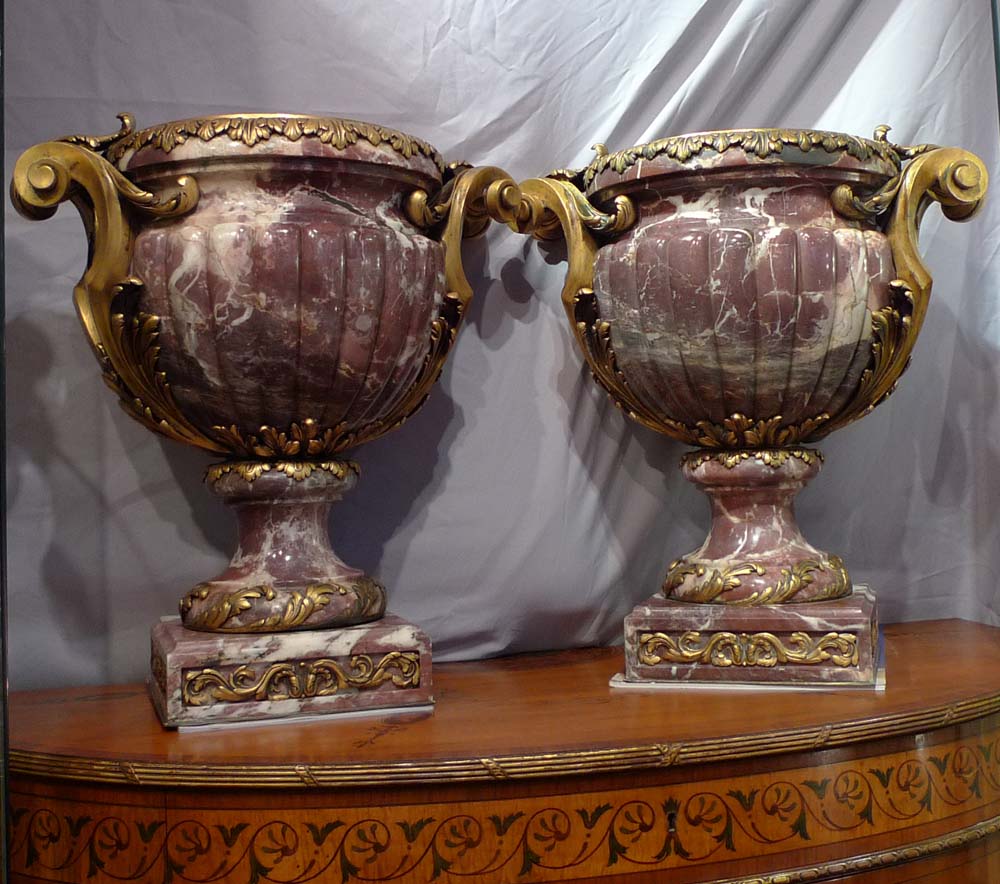 Antique and monumental pair of ormolu mounted breche violet urns.