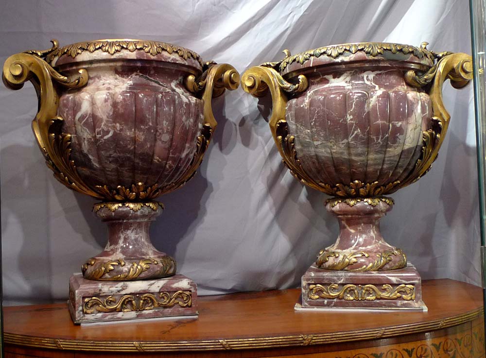 Antique and monumental pair of ormolu mounted breche violet urns.
