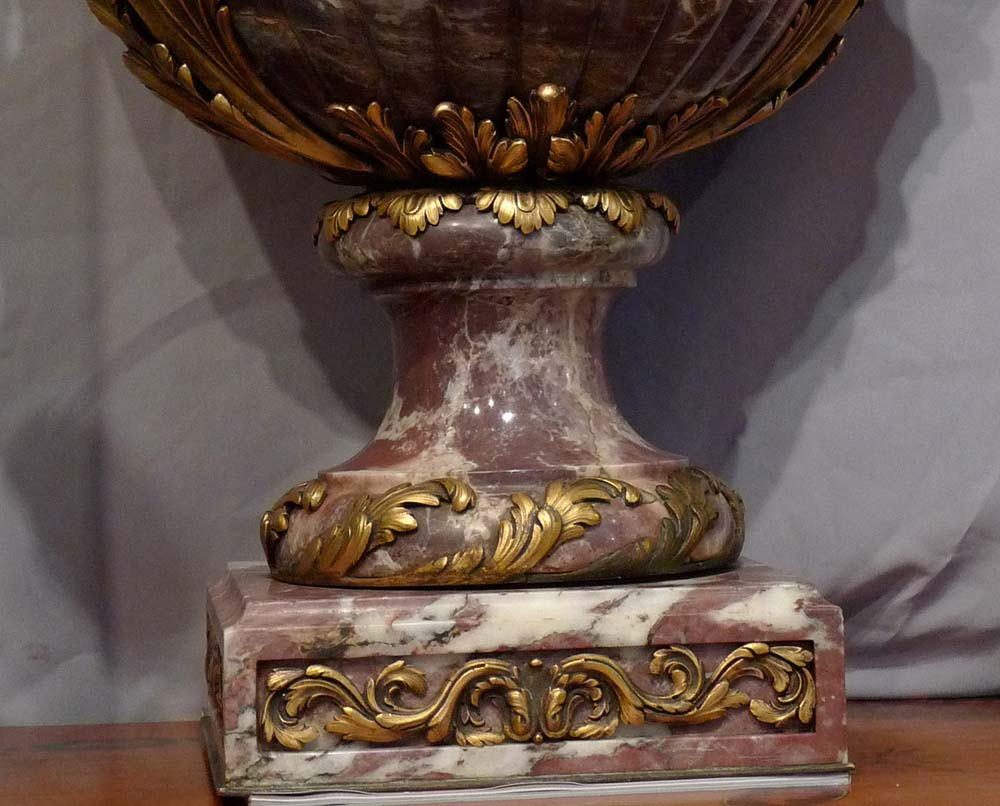 Antique and monumental pair of ormolu mounted breche violet urns.