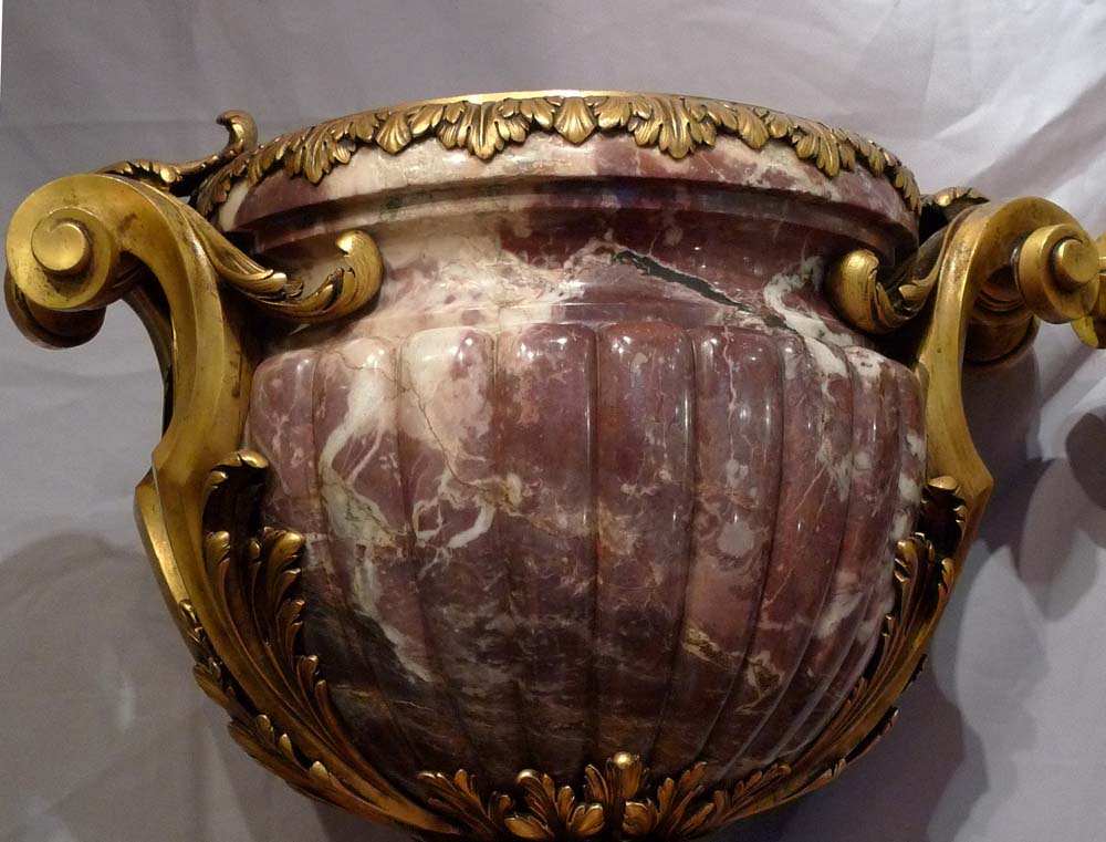 Antique and monumental pair of ormolu mounted breche violet urns.