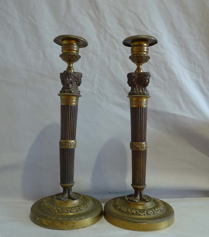 Pair ormolu and patinated bronze candlesticks with masks and feet base with reeded columns.