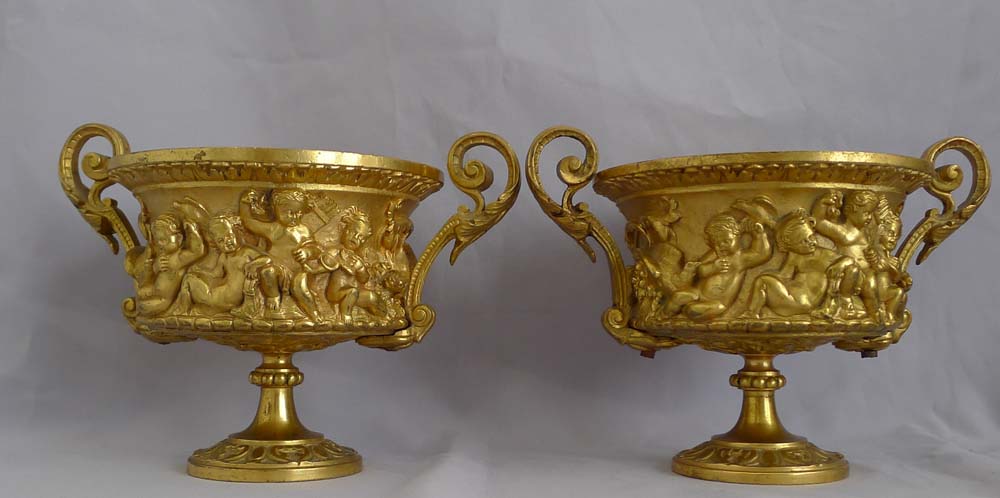 Antique pair of French gilt bronze tazzas with eight putti around the sides.