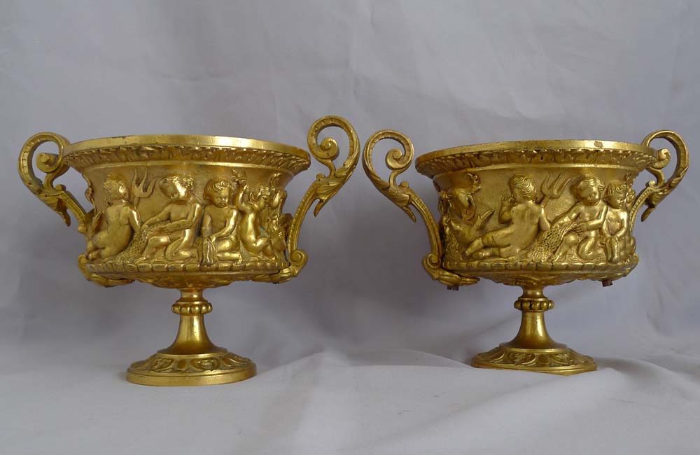Antique pair of French gilt bronze tazzas with eight putti around the sides.