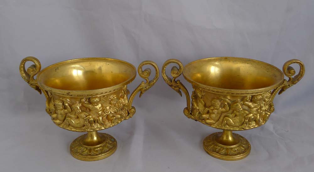 Antique pair of French gilt bronze tazzas with eight putti around the sides.