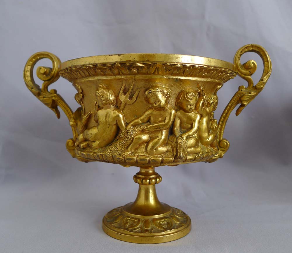 Antique pair of French gilt bronze tazzas with eight putti around the sides.