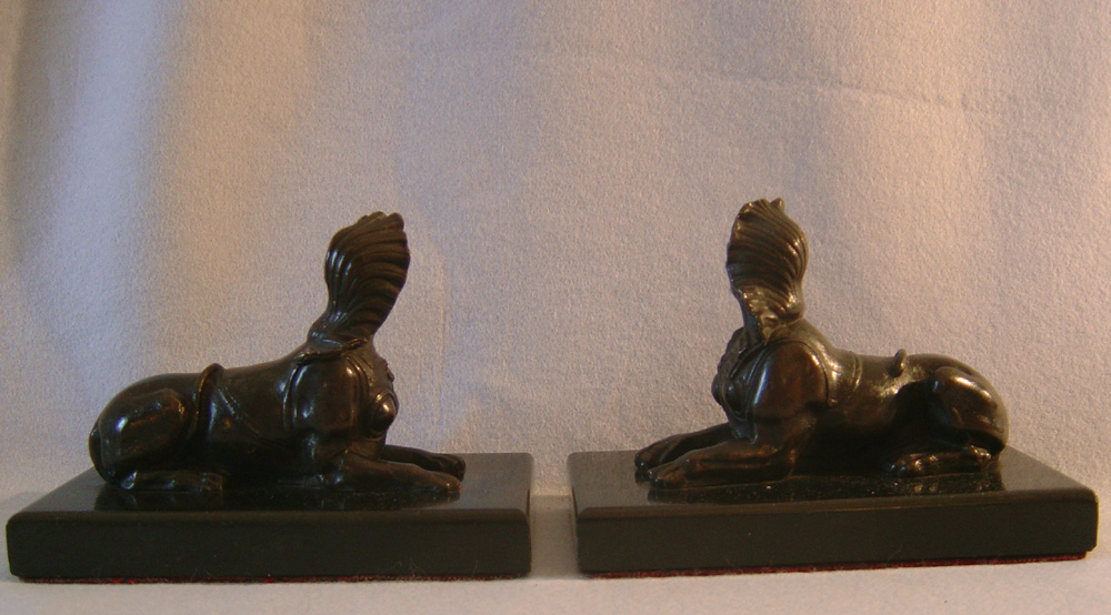 Antique pair of Grand Tour Sphinx on black marble bases.