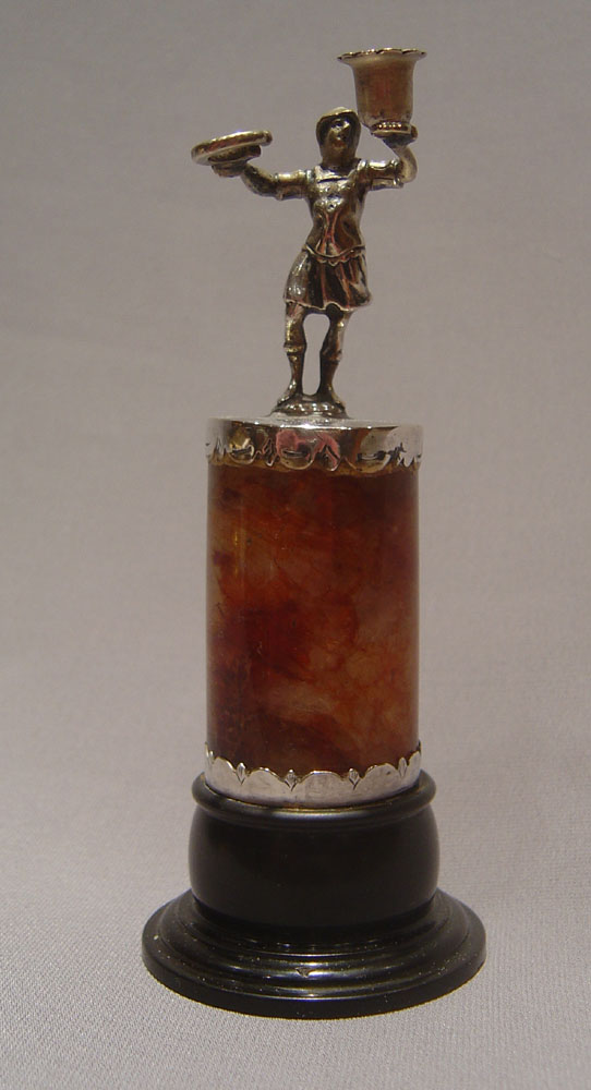 Continental figural taperstick on fleurospar base with black marble socle.