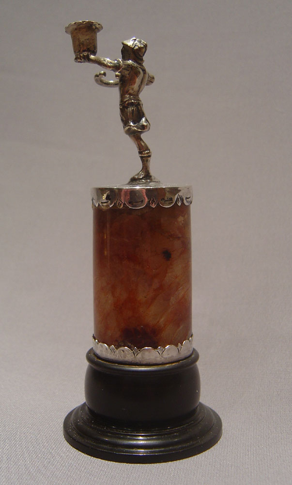 Continental figural taperstick on fleurospar base with black marble socle.