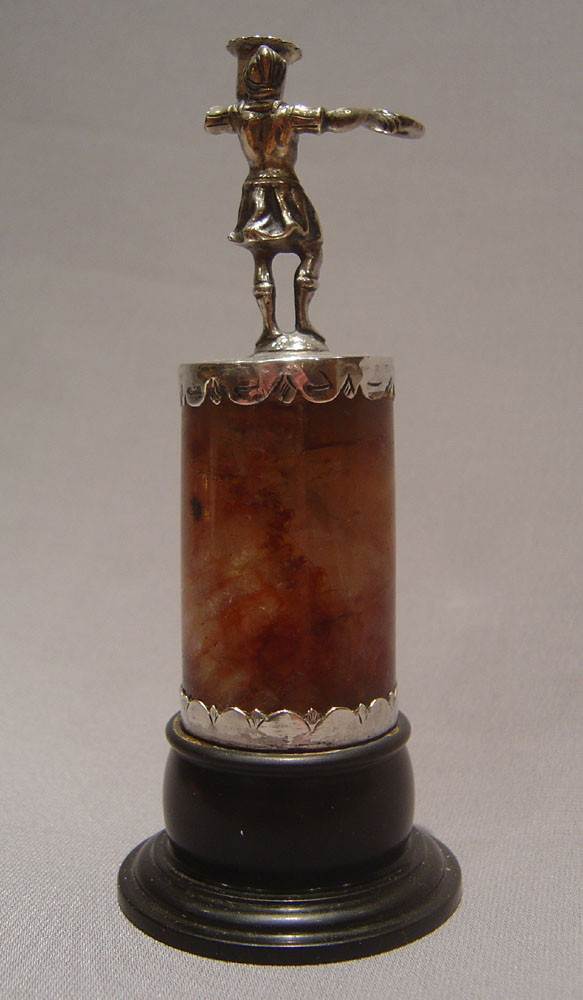 Continental figural taperstick on fleurospar base with black marble socle.