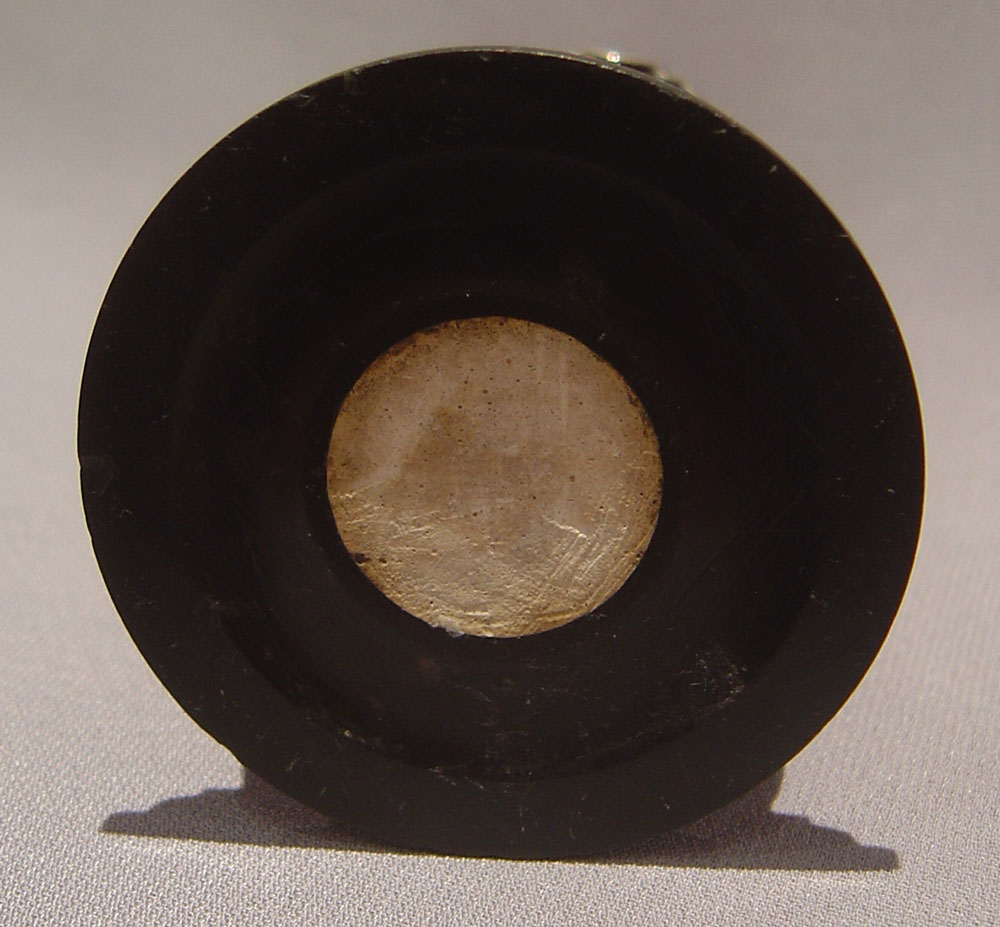 Continental figural taperstick on fleurospar base with black marble socle.