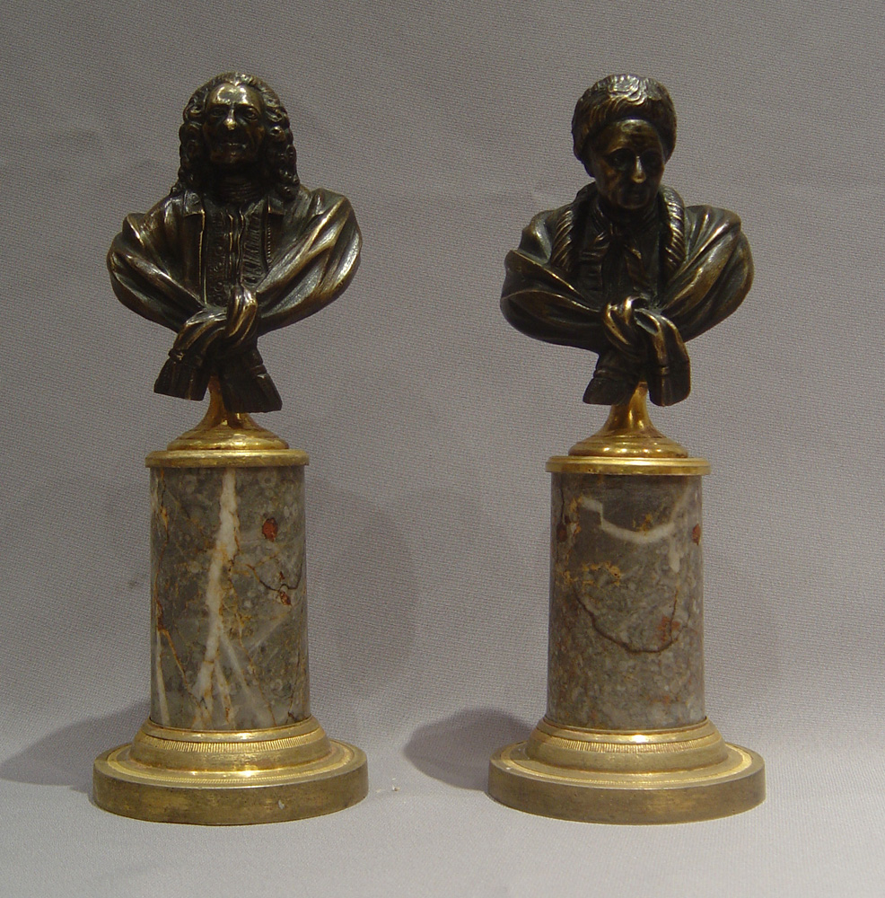 Antique bronze busts of Voltaire and Rousseau on fine ormolu mounted marble bases.