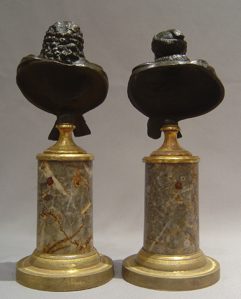 Antique bronze busts of Voltaire and Rousseau on fine ormolu mounted marble bases.
