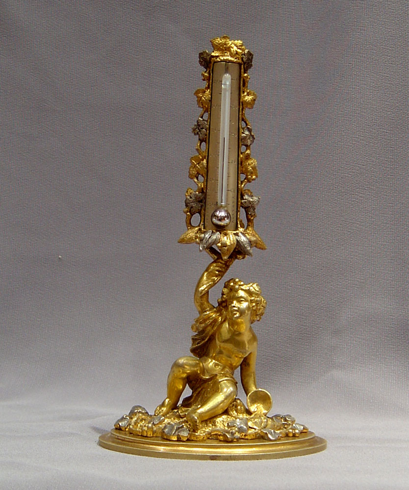 A fine mid 19th century silvered and gilded ormolu thermometer.