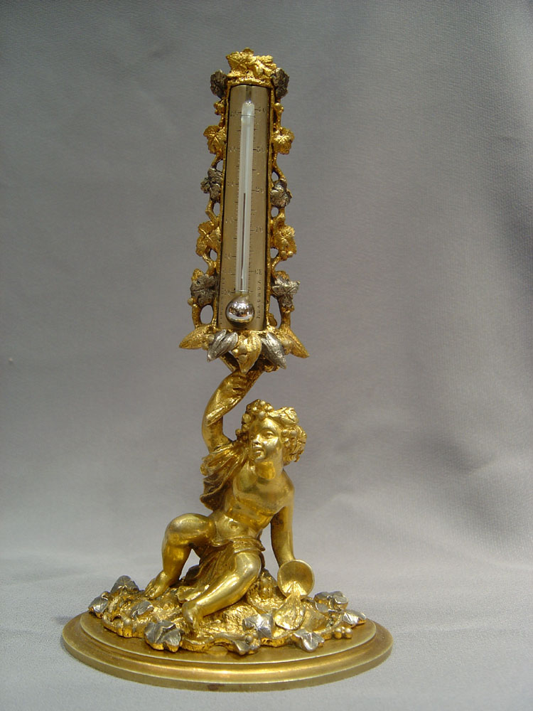 A fine mid 19th century silvered and gilded ormolu thermometer.
