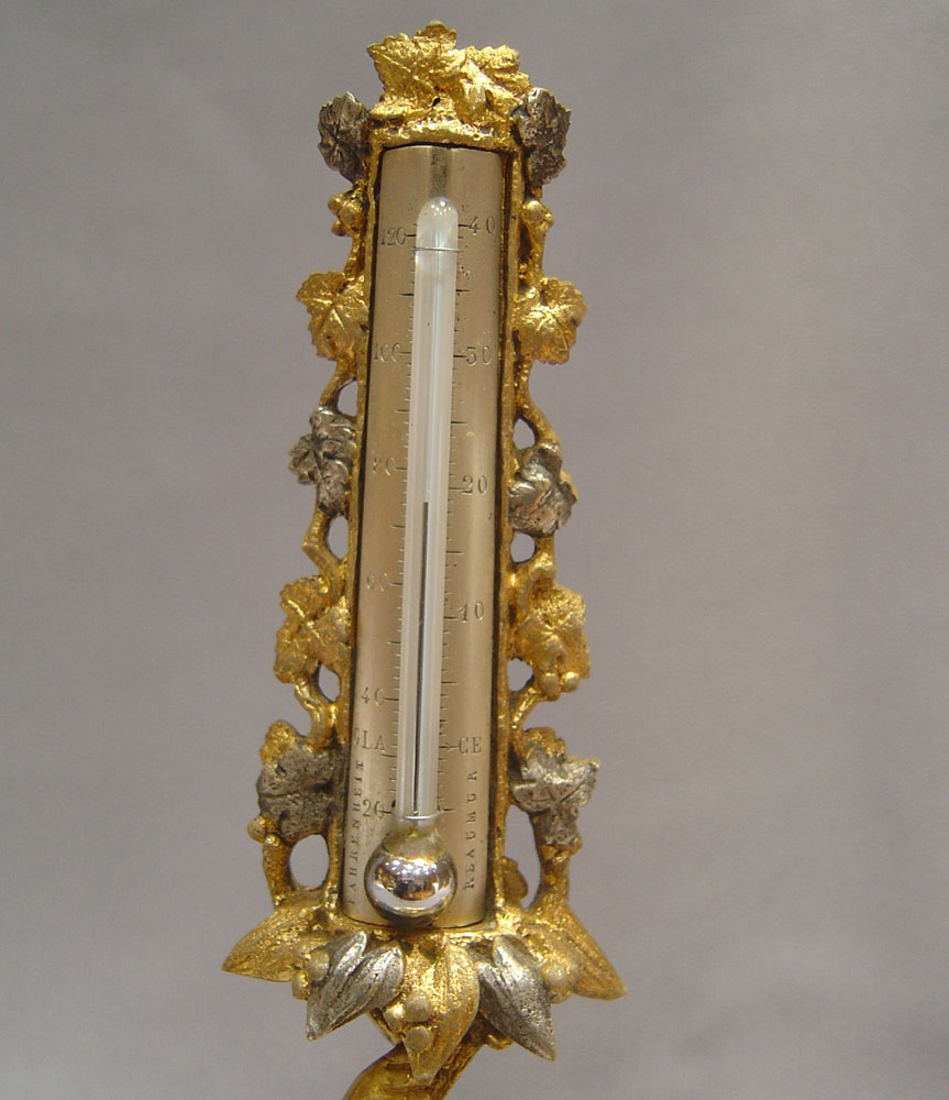 A fine mid 19th century silvered and gilded ormolu thermometer.