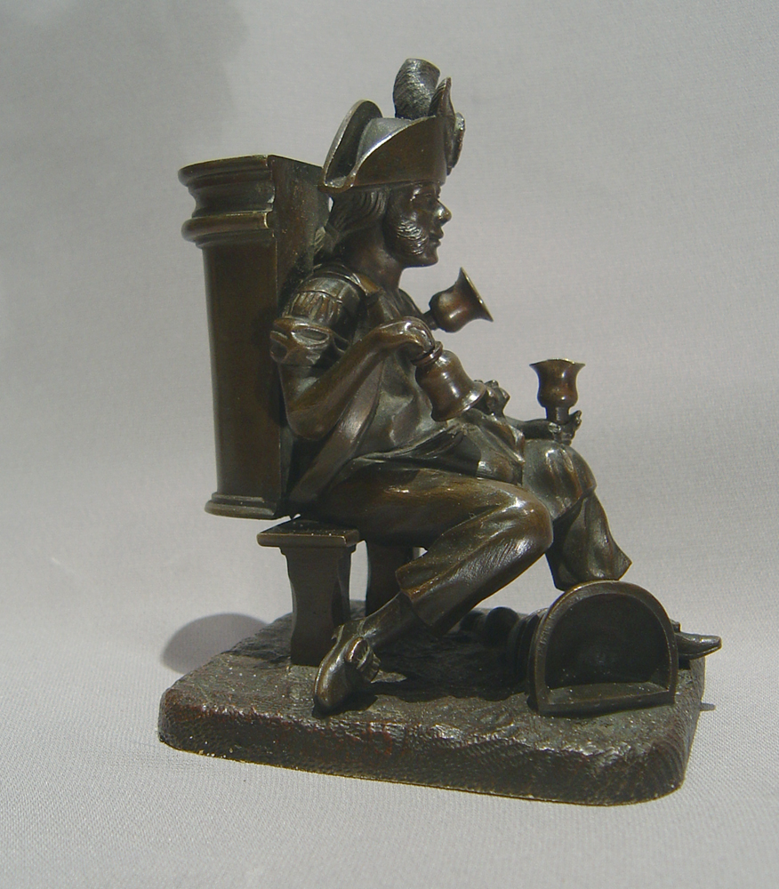 Antique French bronze match strike in the form of an  old soldier as a water seller.