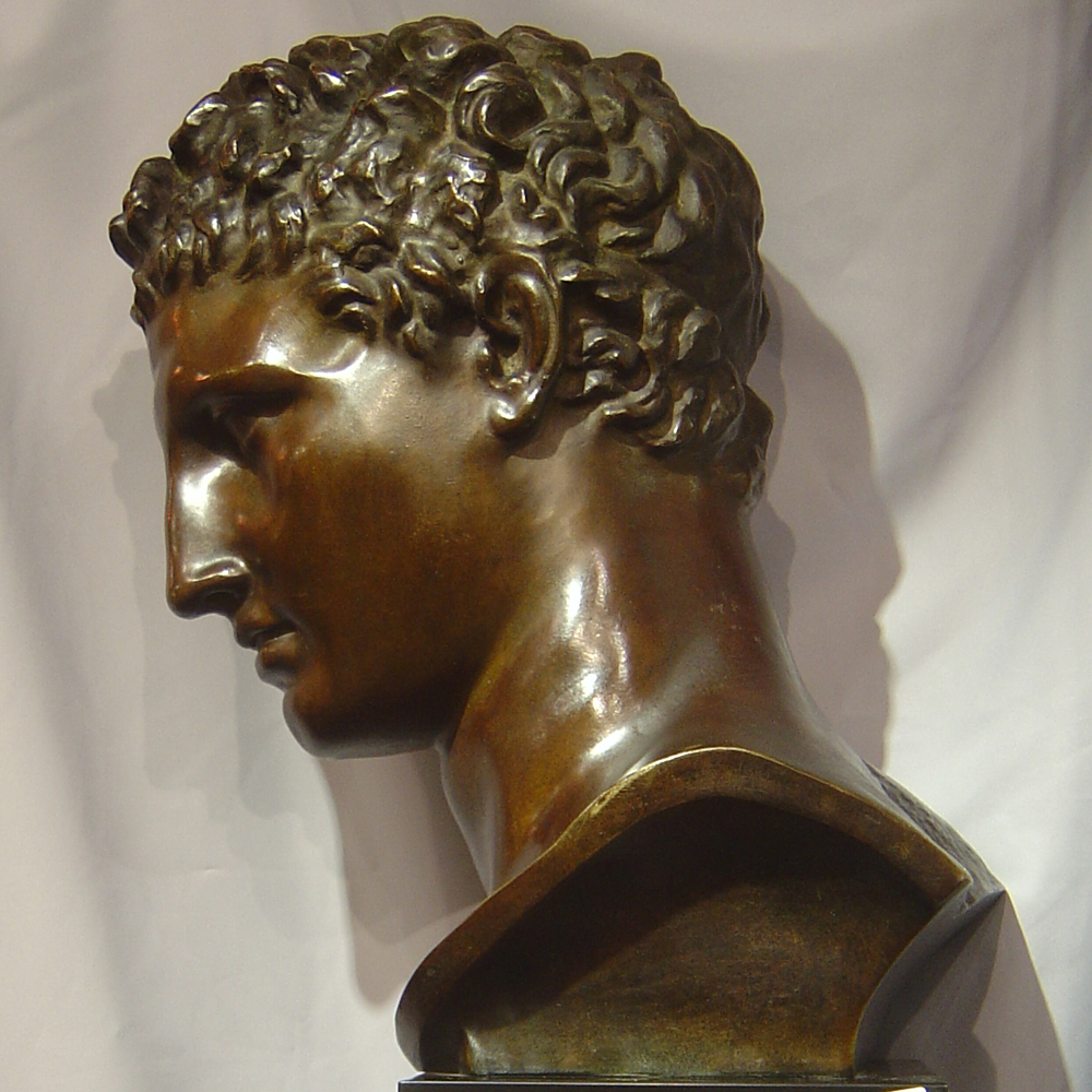 Large bronze bust of male on marble base.