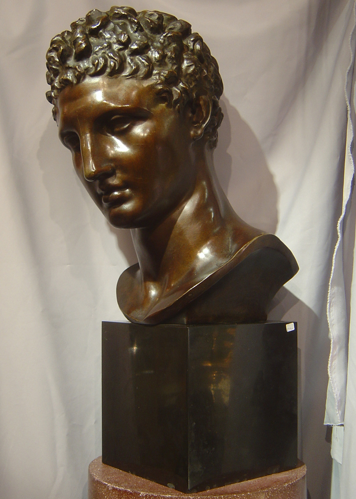 Large bronze bust of male on marble base.