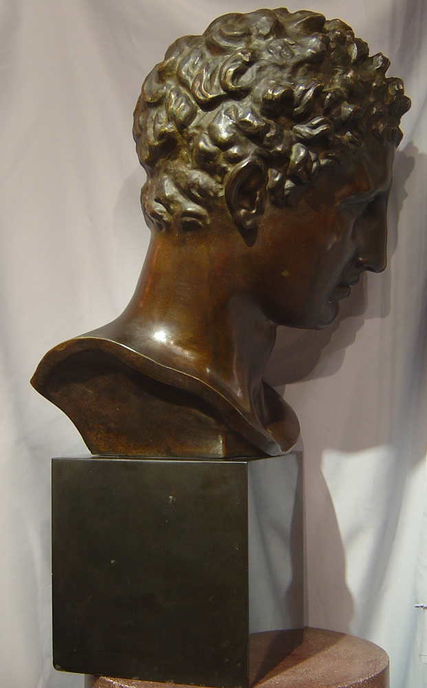 Large bronze bust of male on marble base.