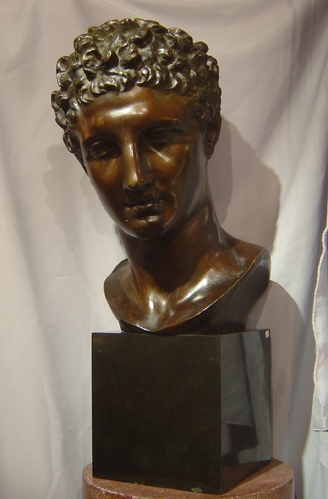 Large bronze bust of male on marble base.