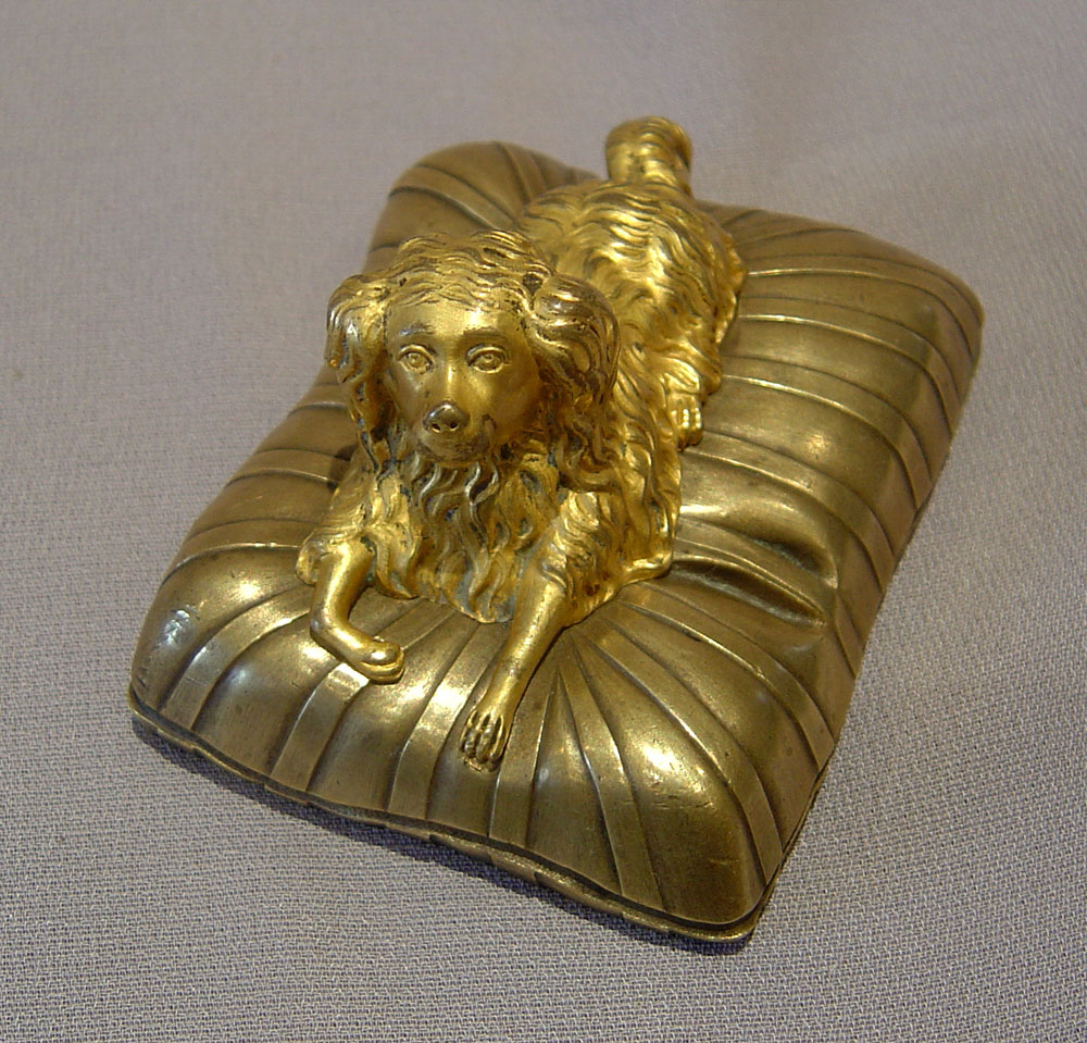 Small bronze of a dog on a cushion, English Regency