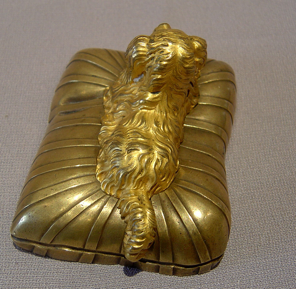 Small bronze of a dog on a cushion, English Regency