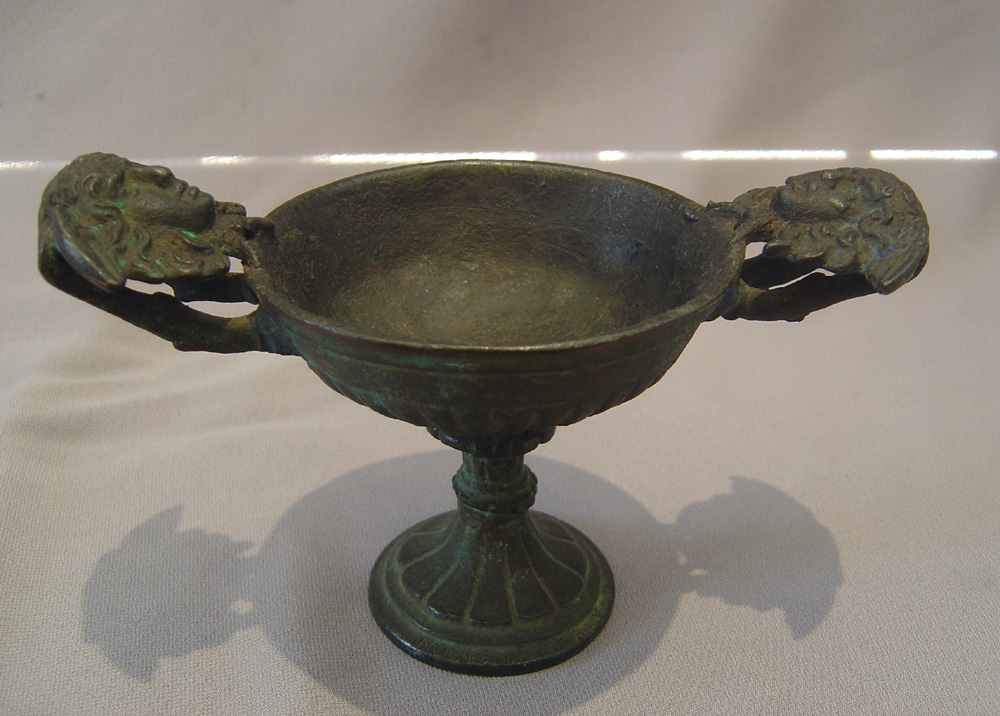 A fine antique Italian goblet with classical masks to the side.