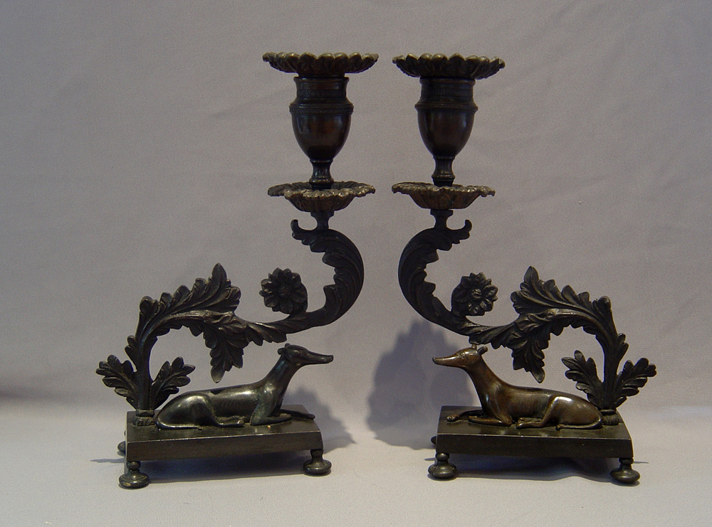 Magnificent antique English Regency pair of patinated bronze greyhound candlesticks.