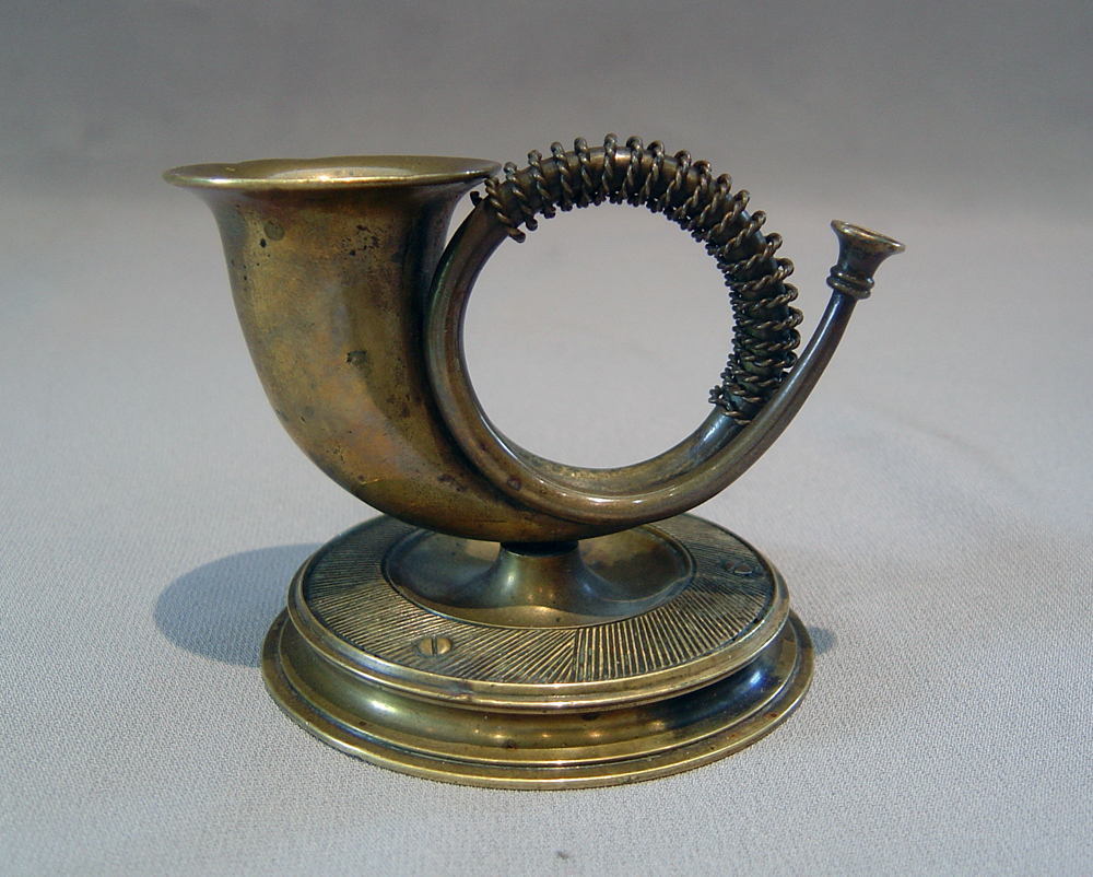 Horn match strike in patinated bronze.