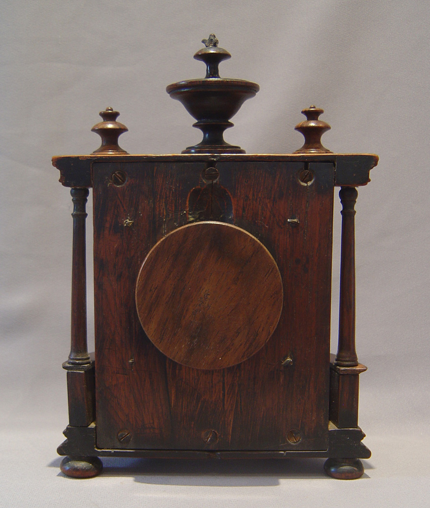 Watch stand in rosewood in bow fronted bronze mounted case with columns and finials.
