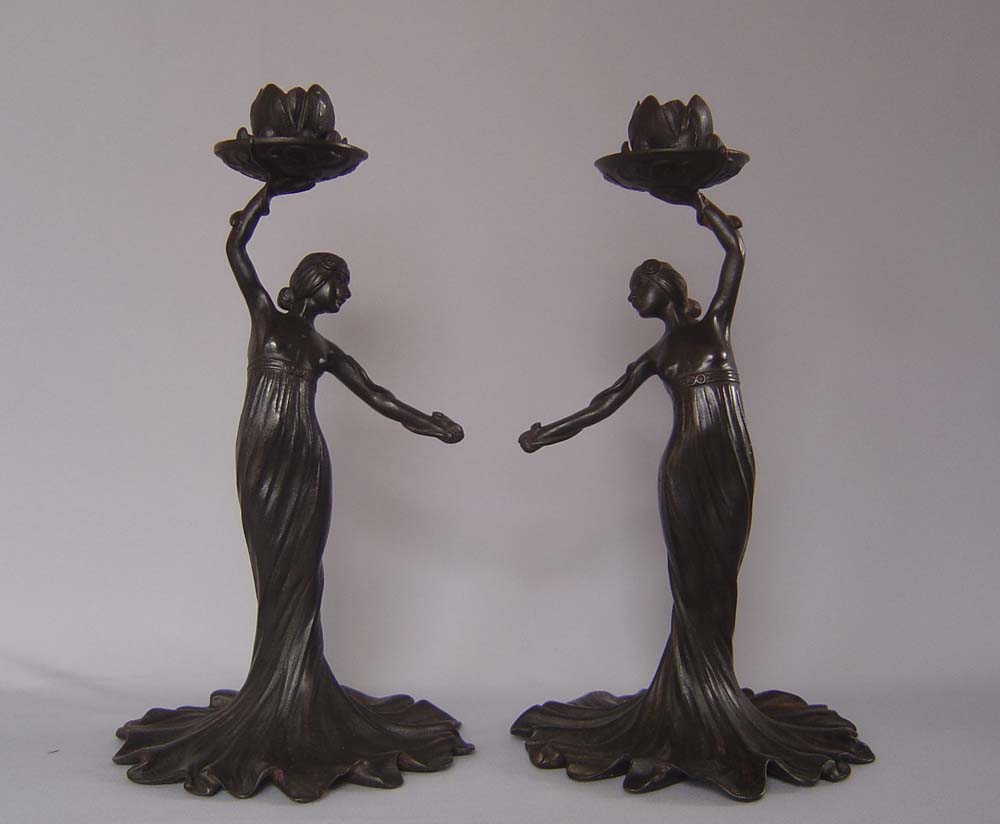 Russian Art nouveau candlesticks, a pair and in cast iron.