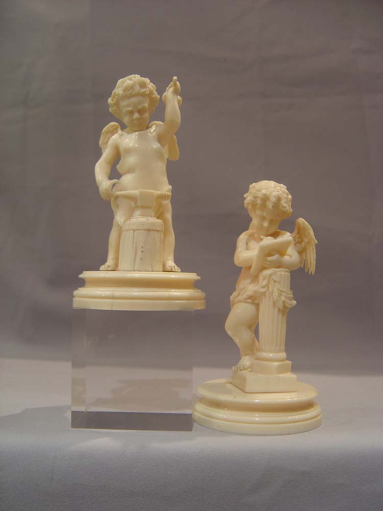 Ivory antique carved cupids, European,a pair, superbly carved
