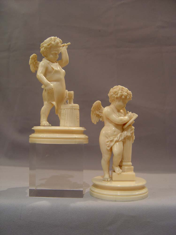 Ivory antique carved cupids, European,a pair, superbly carved