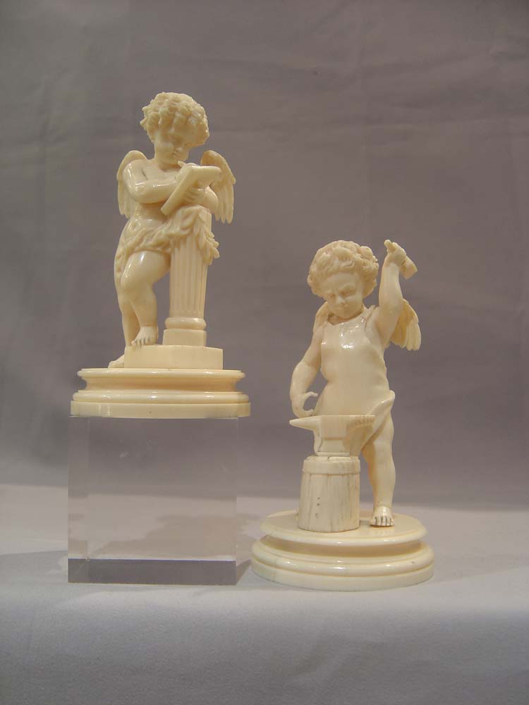 Ivory antique carved cupids, European,a pair, superbly carved