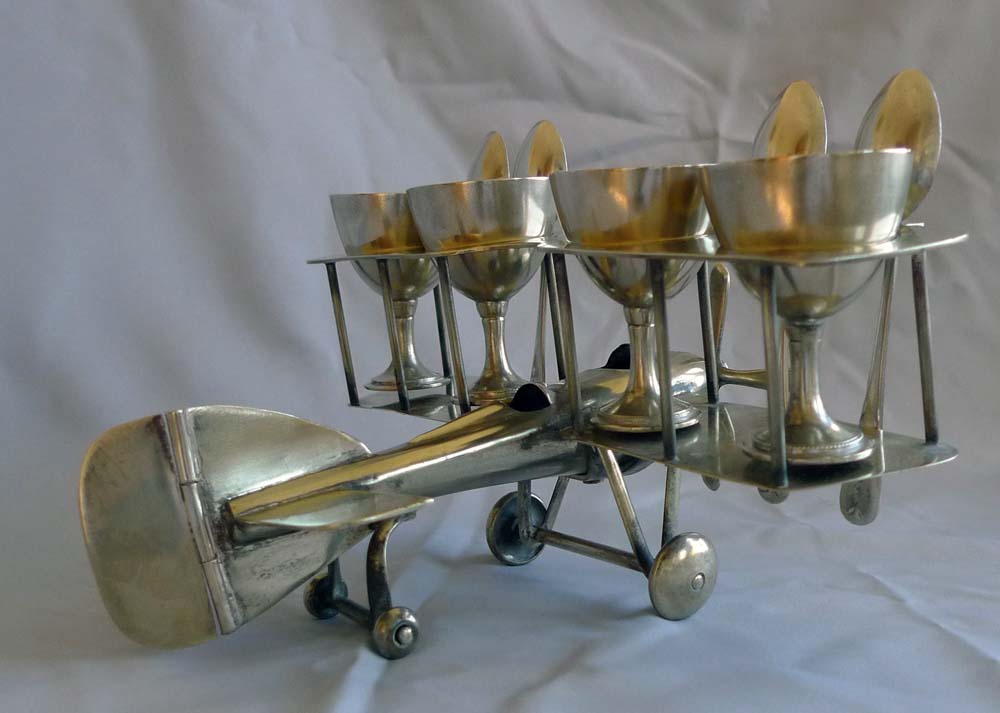 Unusual Art Deco bi-plane egg cup set.