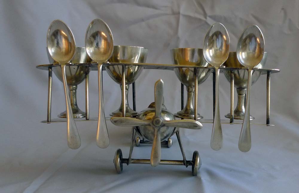 Unusual Art Deco bi-plane egg cup set.
