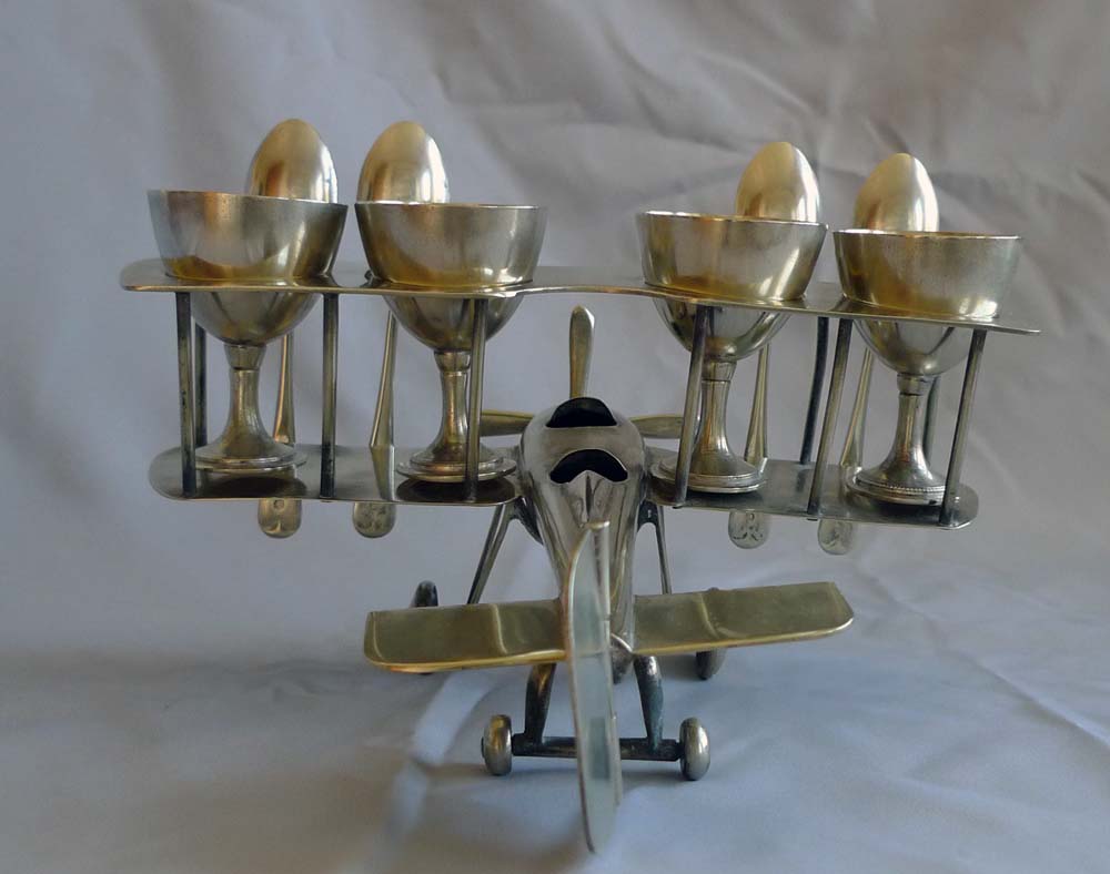 Unusual Art Deco bi-plane egg cup set.