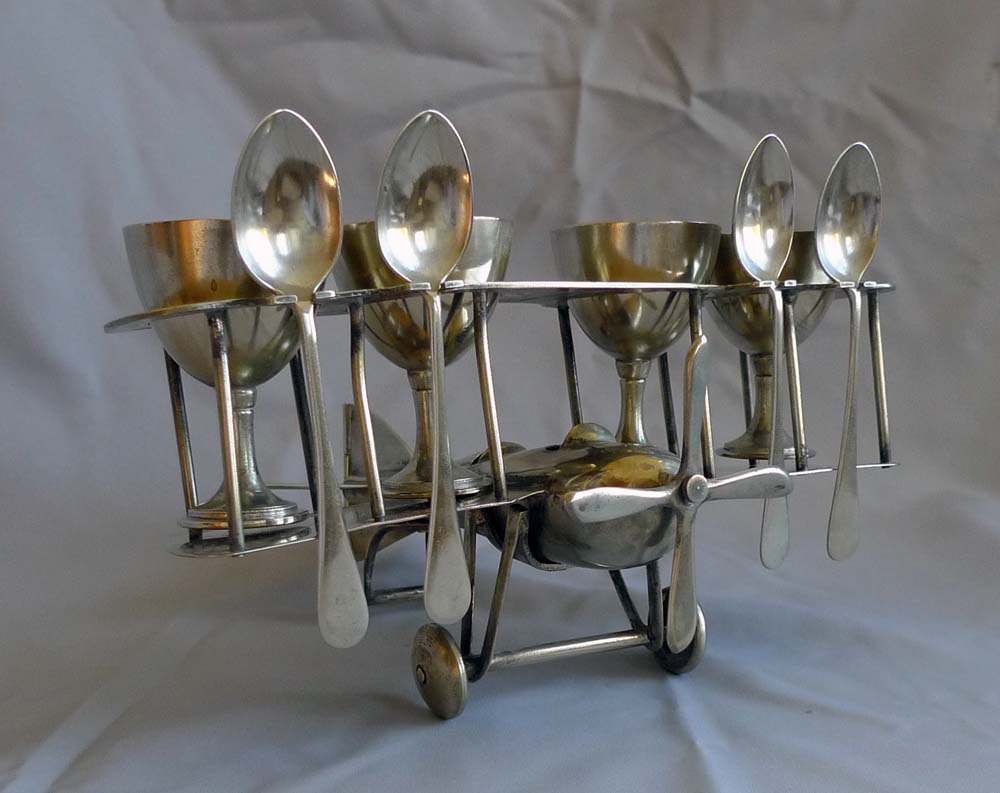 Unusual Art Deco bi-plane egg cup set.
