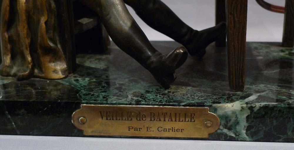 Antique Napoleon Bonaparte figural lamp showing Napoleon seated at a table.