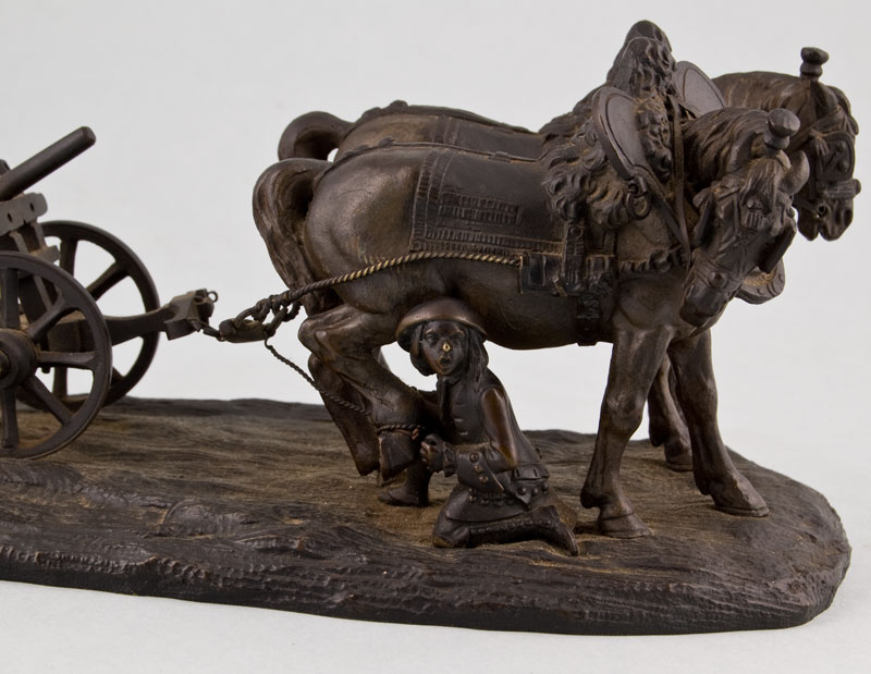 Antique bronze of working horses with plough, tended by groom.