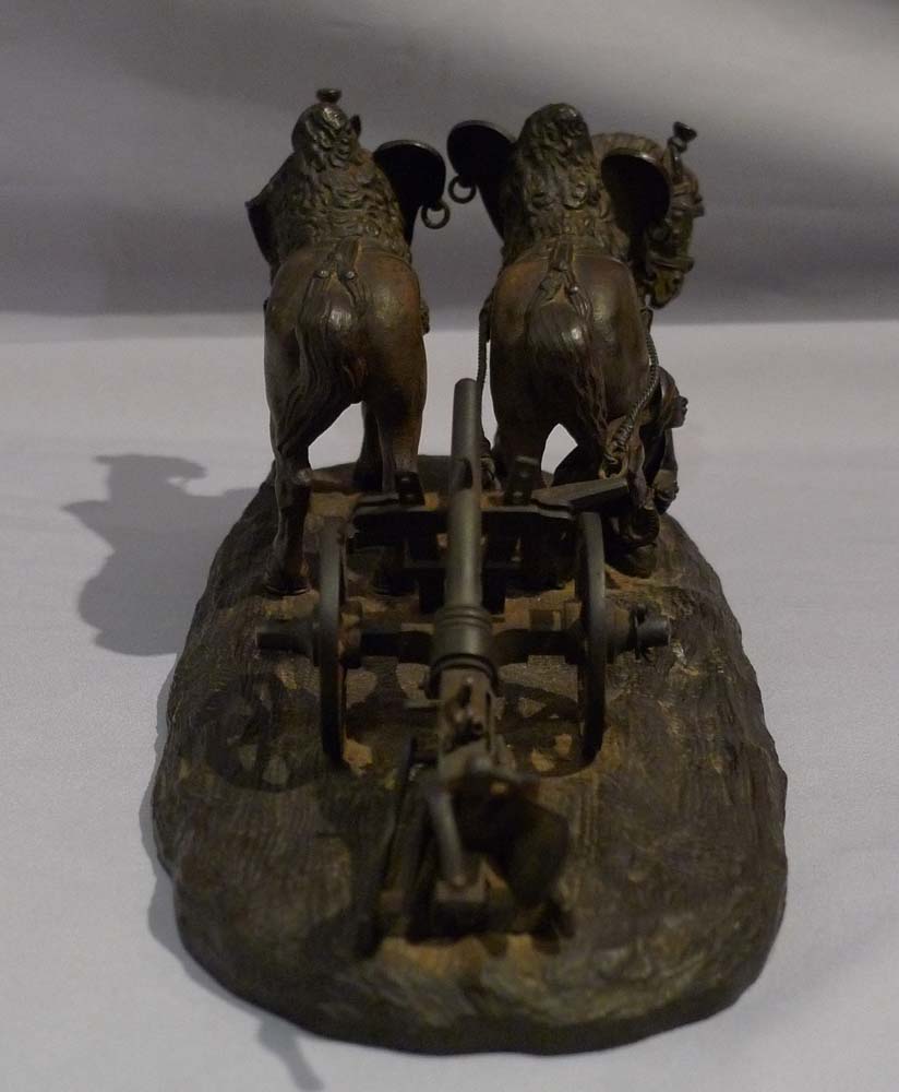 Antique bronze of working horses with plough, tended by groom.