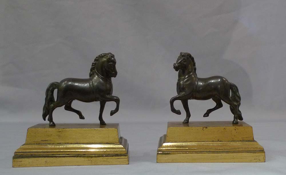 Pair English Geoge IV gilt lacquered models of classical horses, on bases and under domes.