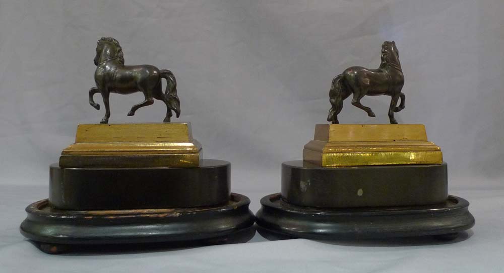 Pair English Geoge IV gilt lacquered models of classical horses, on bases and under domes.