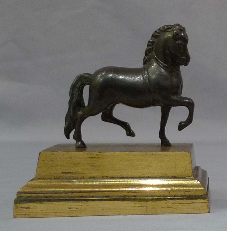 Pair English Geoge IV gilt lacquered models of classical horses, on bases and under domes.