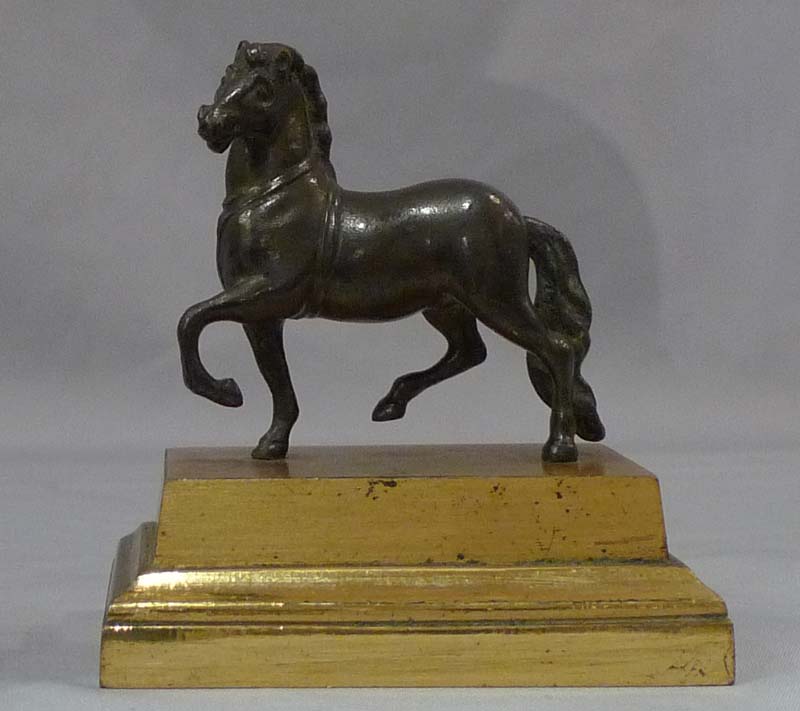 Pair English Geoge IV gilt lacquered models of classical horses, on bases and under domes.