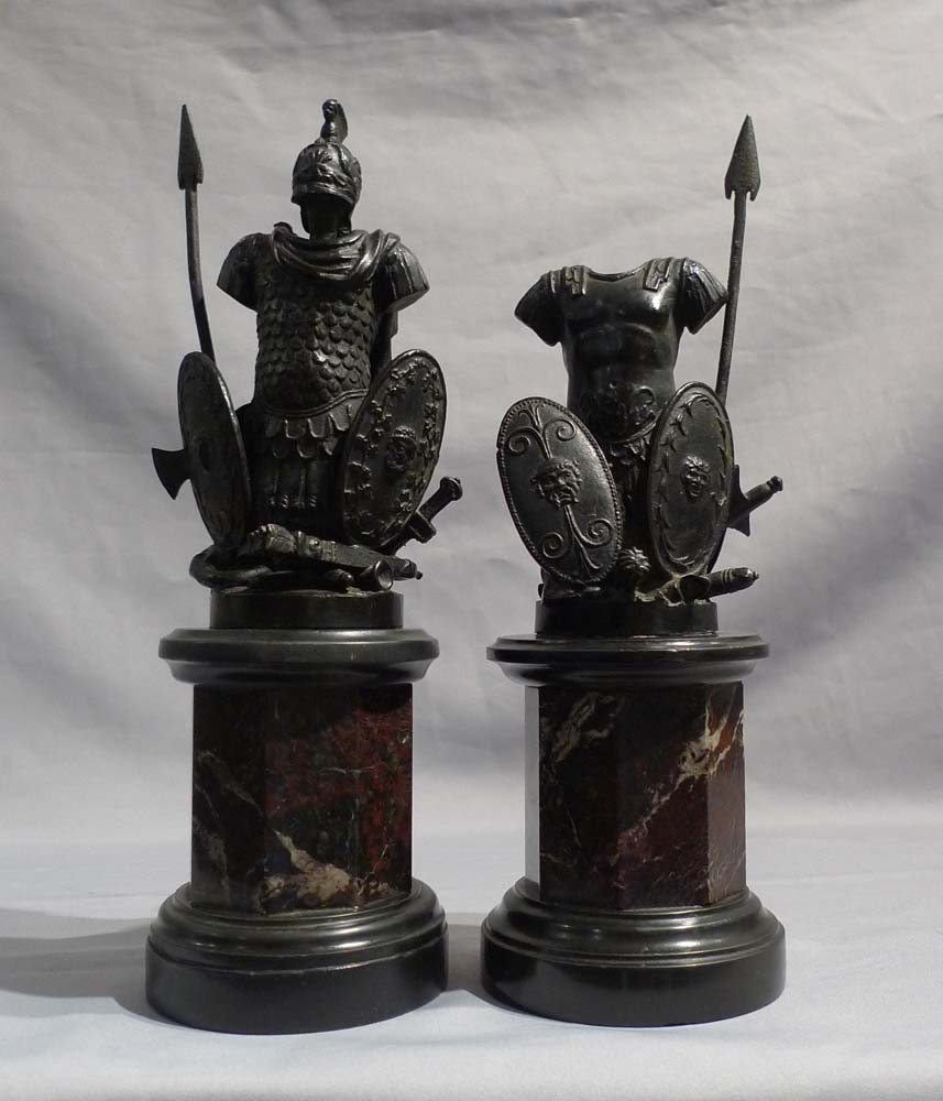 Pair antique grand tour bronze trophies of war on black marble and shaped variagated marble stems.