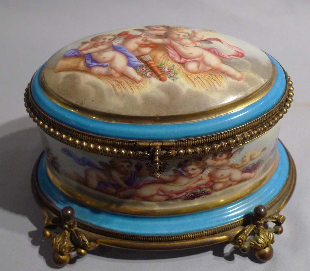 Antique French porcelain and ormolu casket with hand painted scenes of cupids..